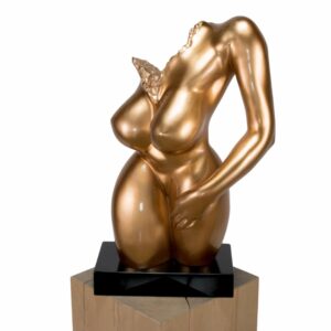 A contemporary metallic gold female form sculpture on a dark base.