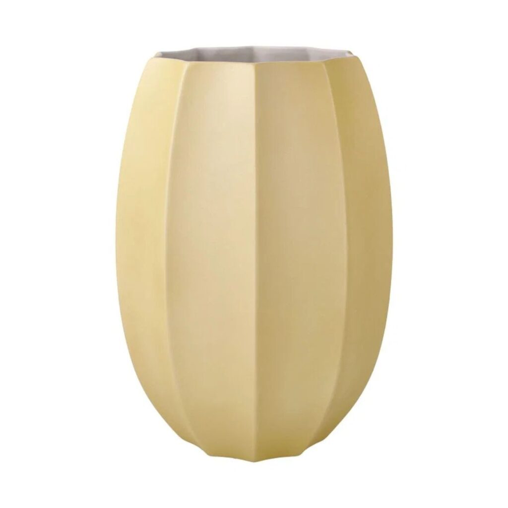 A minimalist faceted matte yellow vase on a plain white background.